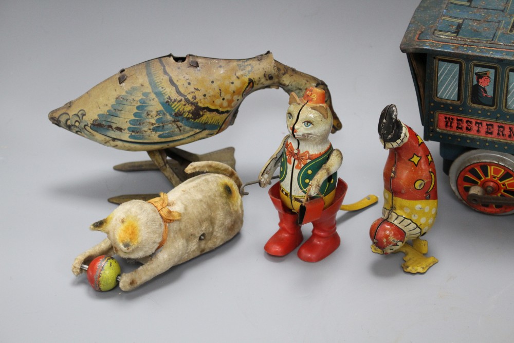 A clockwork cat and ball, and four assorted tinplate toys